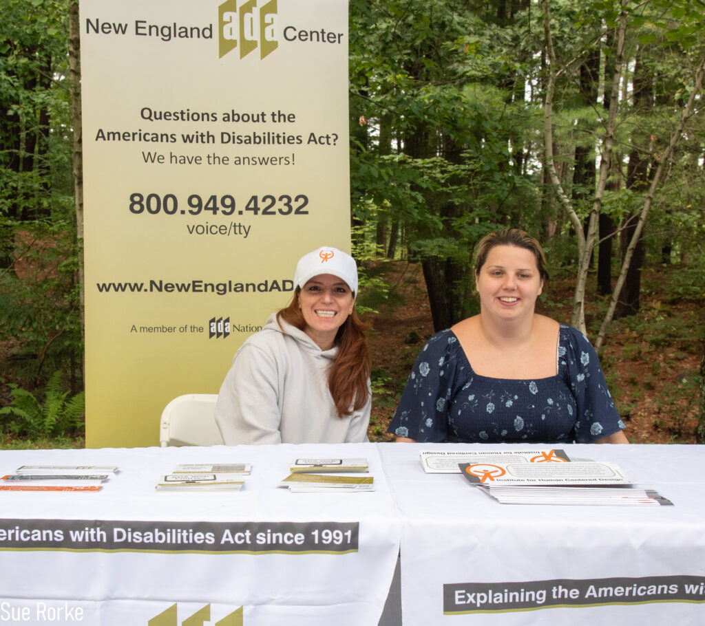 New England ADA Center table with 2 smiling women