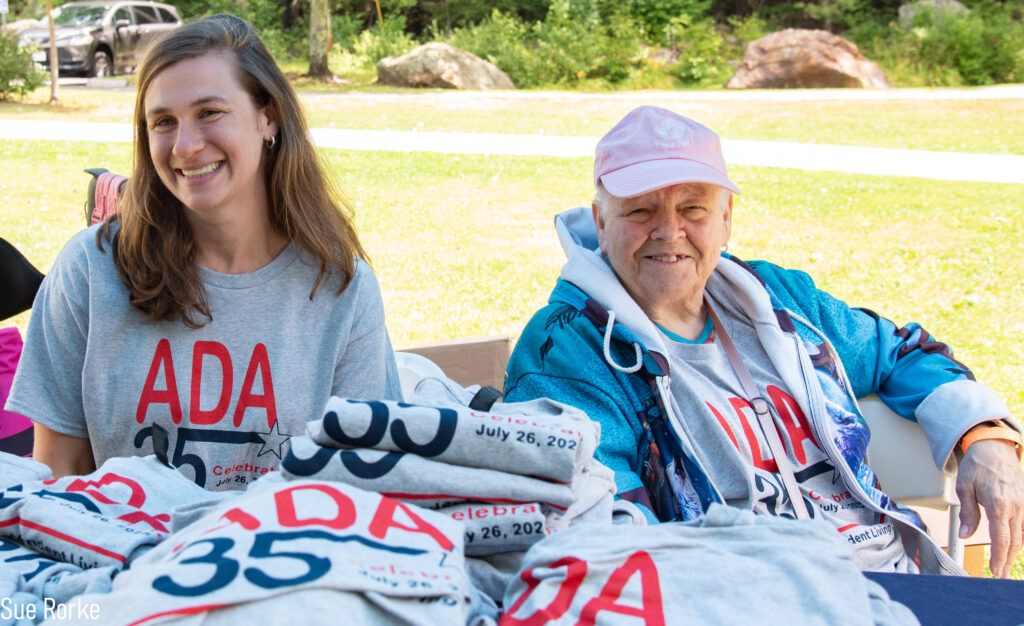 Aliza (MASILC) and Sandy at the tee shirt table