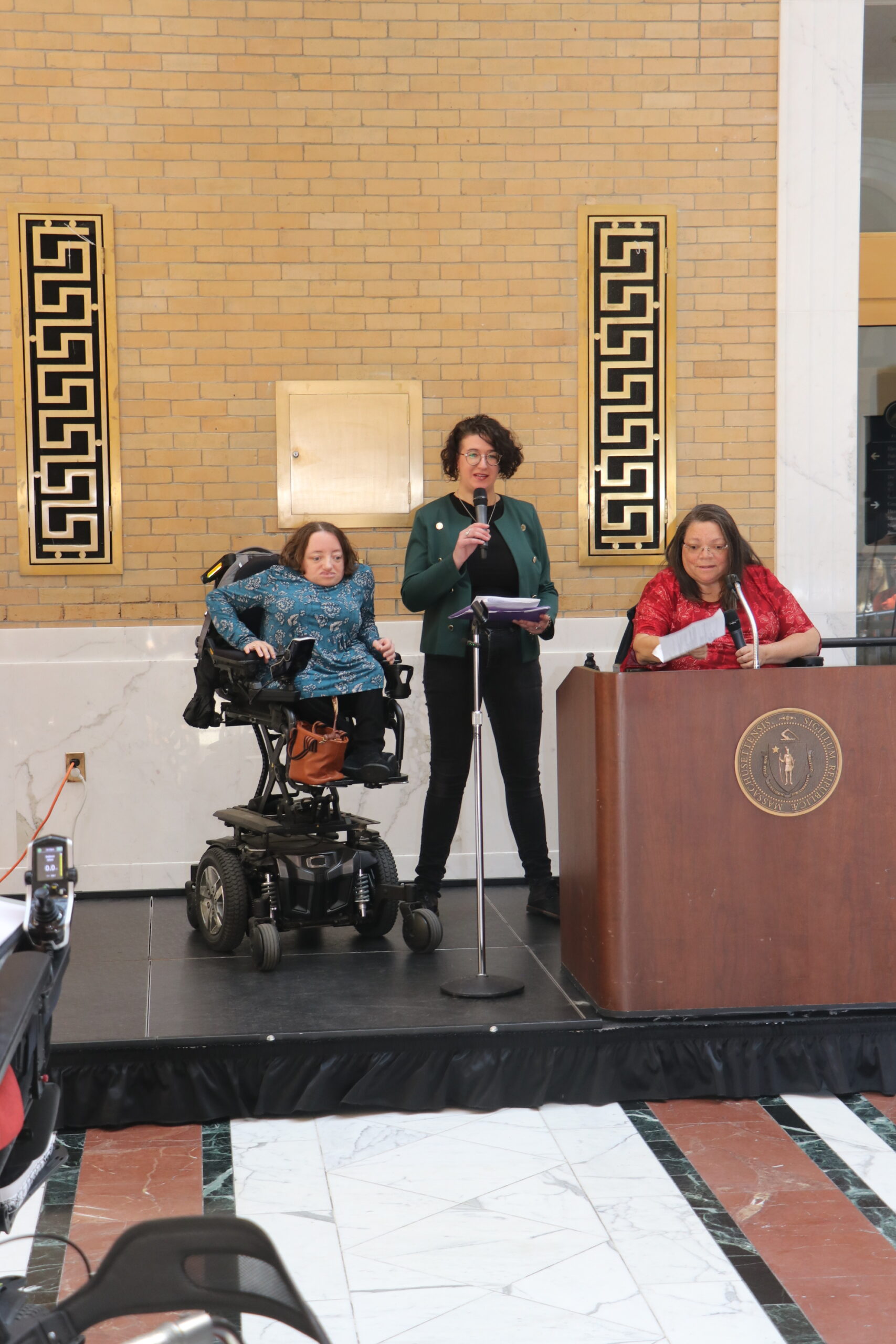 Desi Forte, Rachel Cowan and Nancy Garr-Colzie at the front of the room. Rachael speaking 