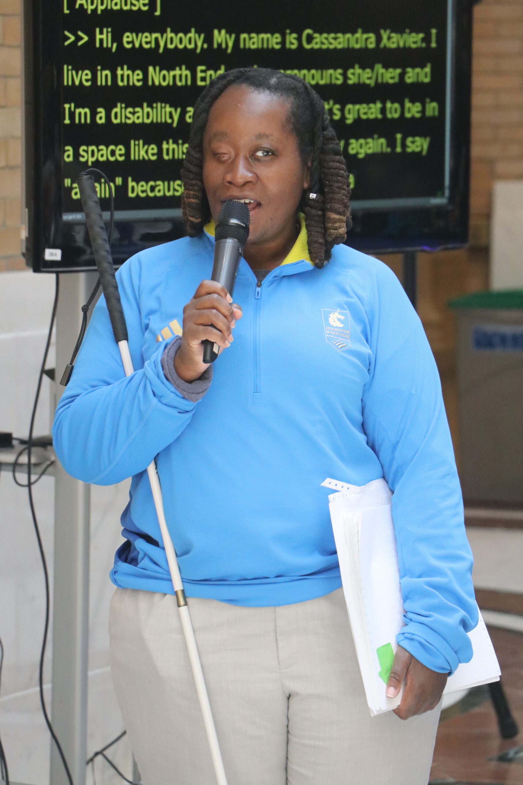 Casandra Xavier, BCIL Board member, standing and speaking