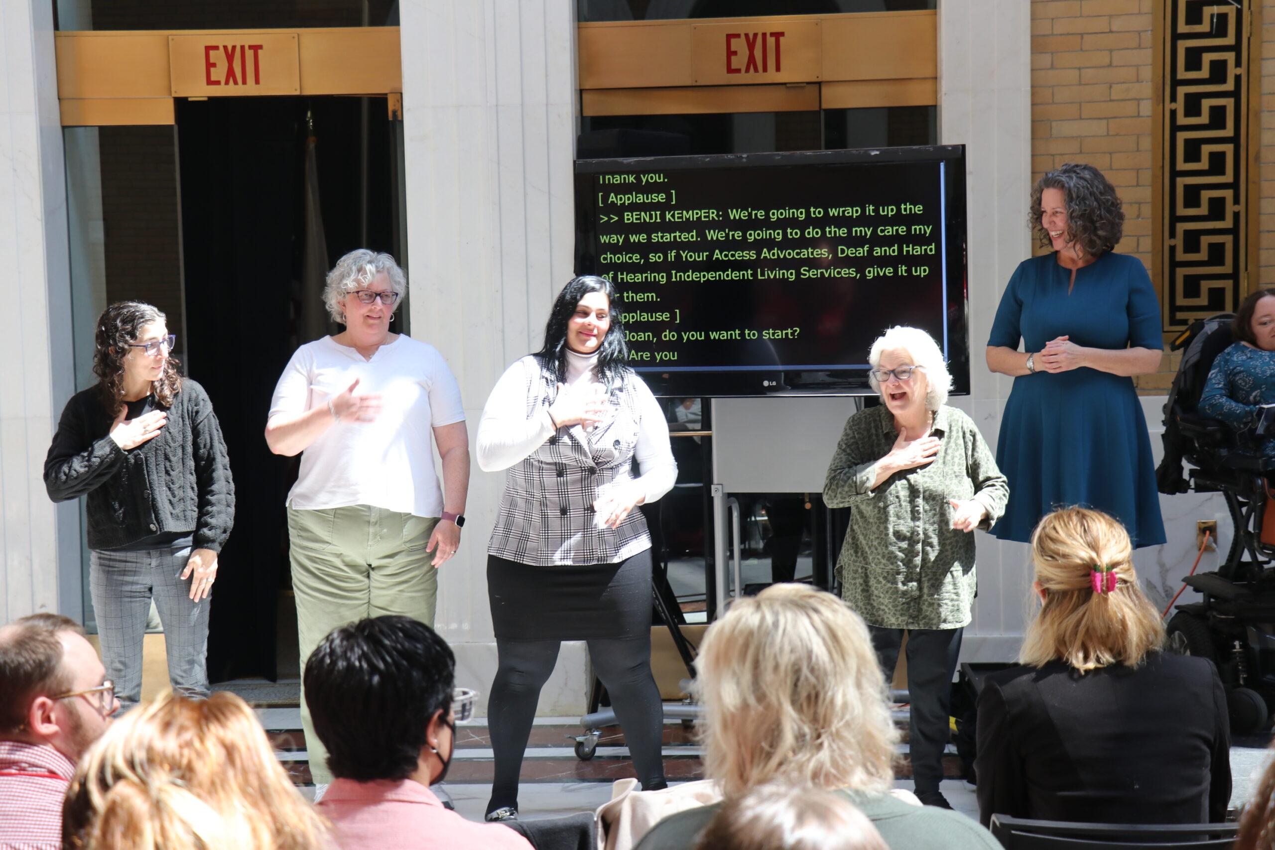 DHILS Program staff leading a chant in ASL