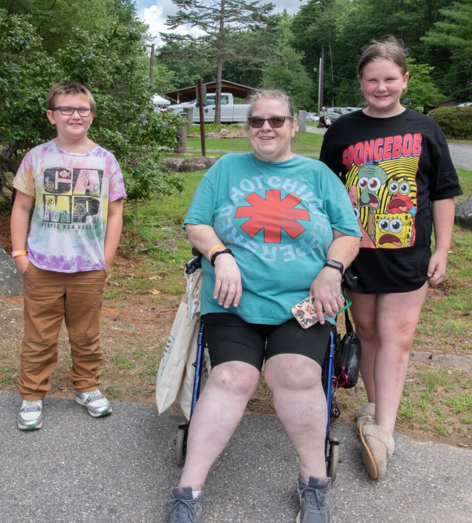 woman in wheelchair with two children
