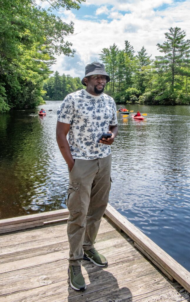 Man posing in front of pond