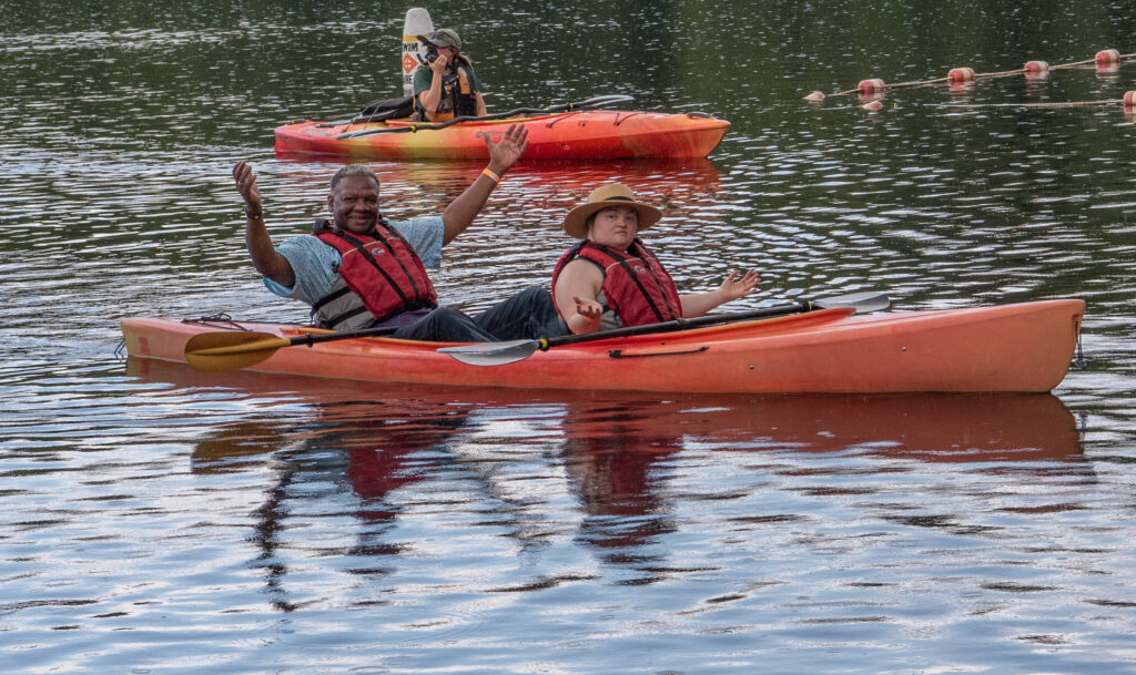 Two people getting rained on in kayak