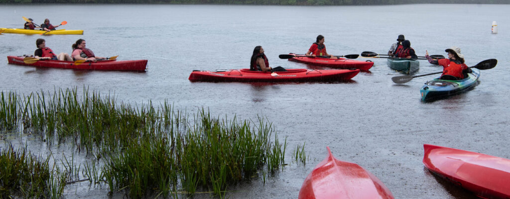 getting rained on in kayaks - hurrying back to shore