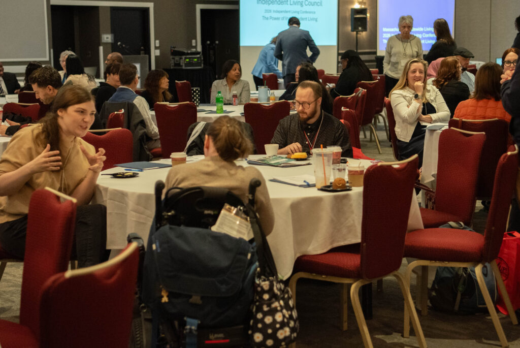 A group of people talking in a big room