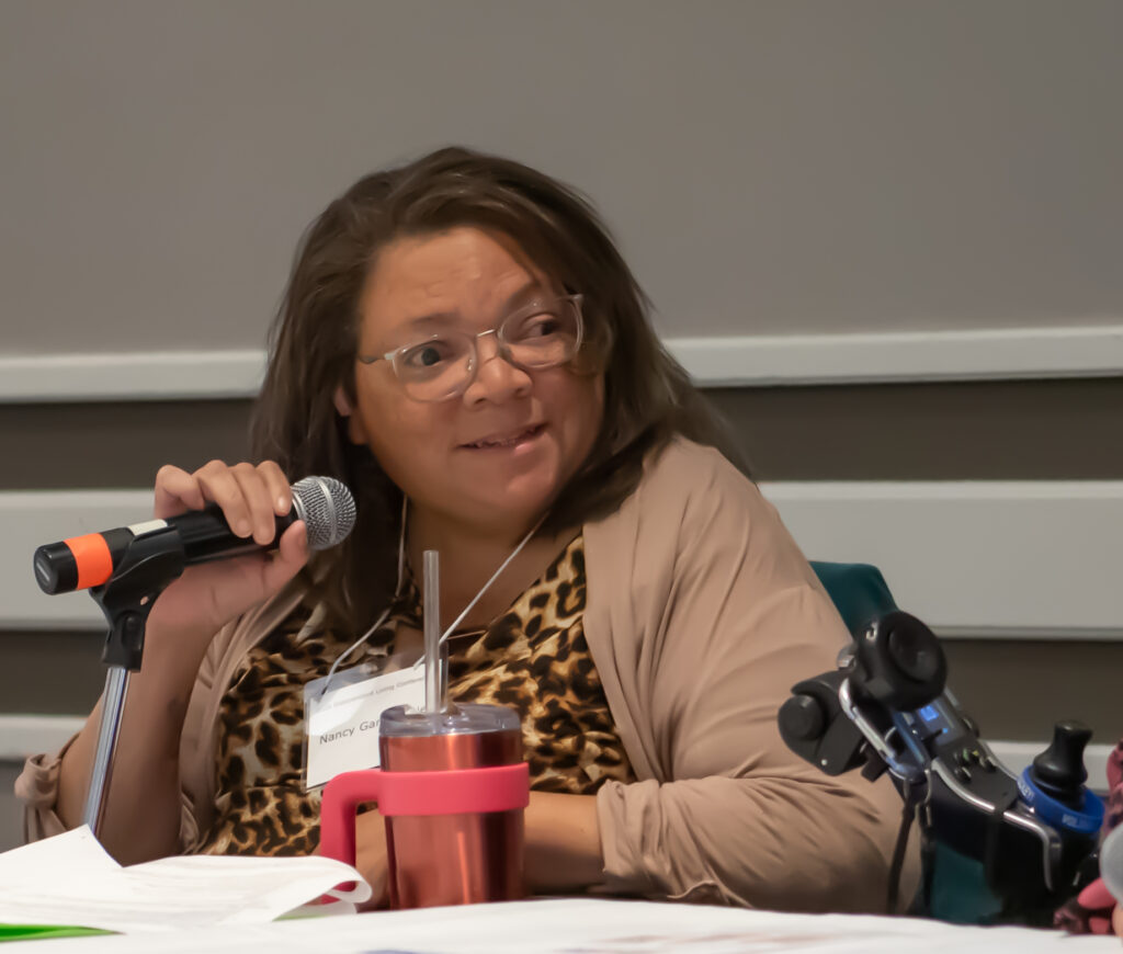 Nancy Garr-Colzie speaking into microphone