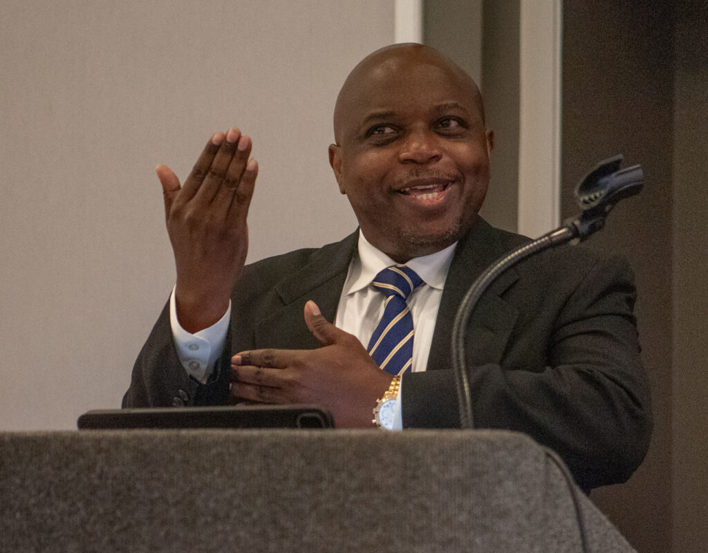 Commissioner Opeoluwa Sotonwa, Massachusetts Commission for the Deaf and Hard of Hearing signing in American Sign Language (ASL)