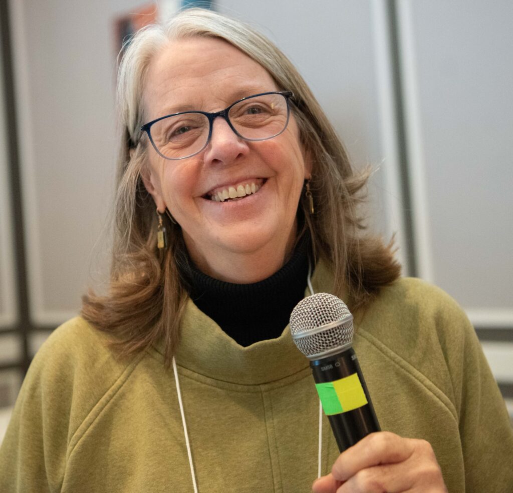 Leslie Leslie, Federation for Children with Special Needs, speaking with microphone and smiling