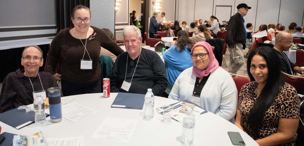 A group of people smiling around a table