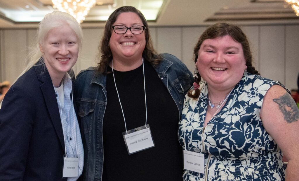 Three people smiling
