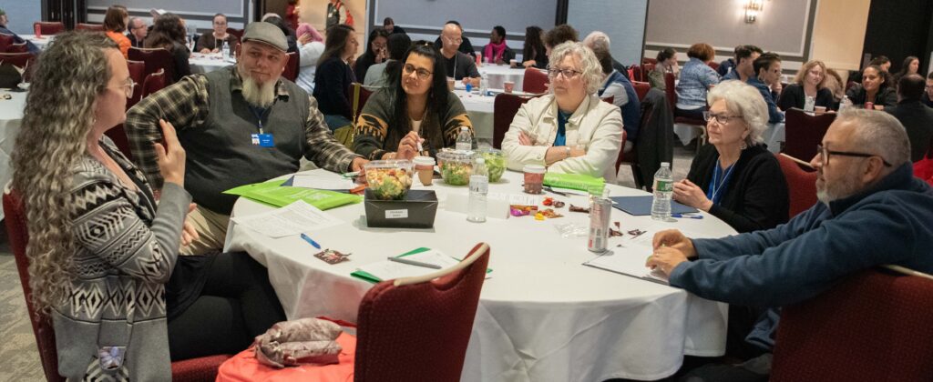 A group of people talking at a table