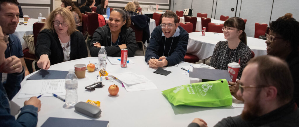 A group of people talking at a table